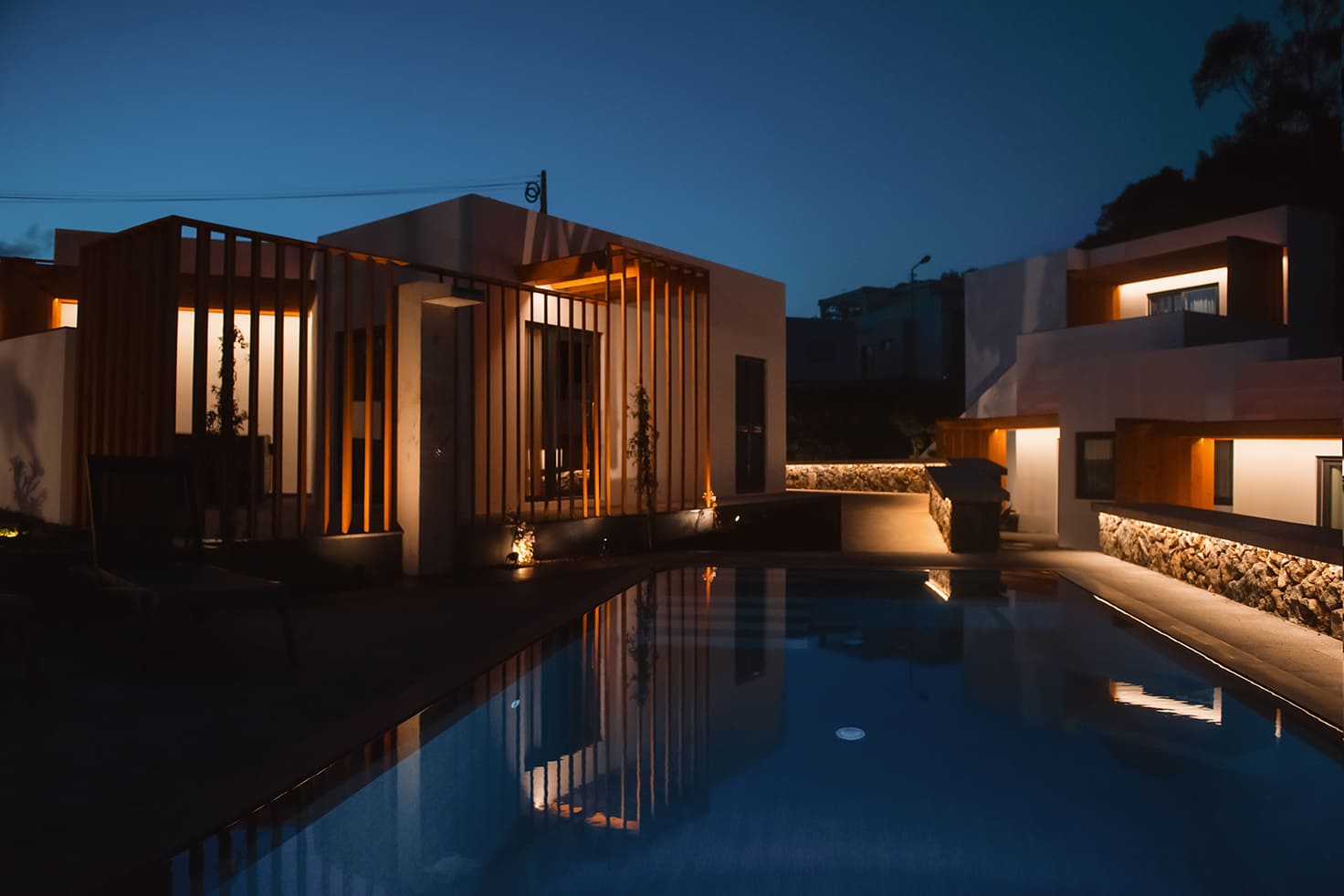 The Vilas do Olival swimming pool lit up at night beside the villas
