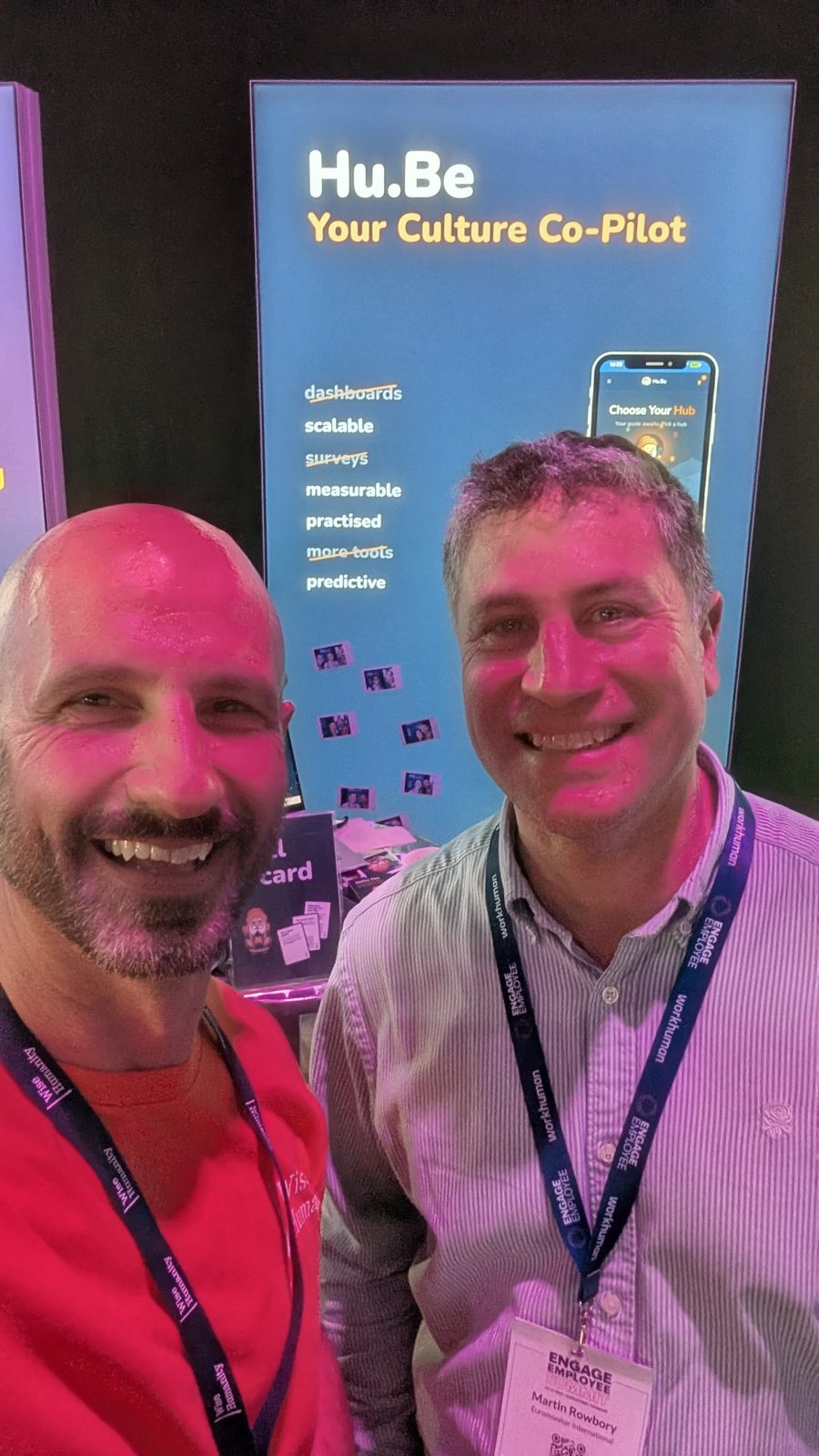 Davide and a visitor talking at the Hu.Be stand