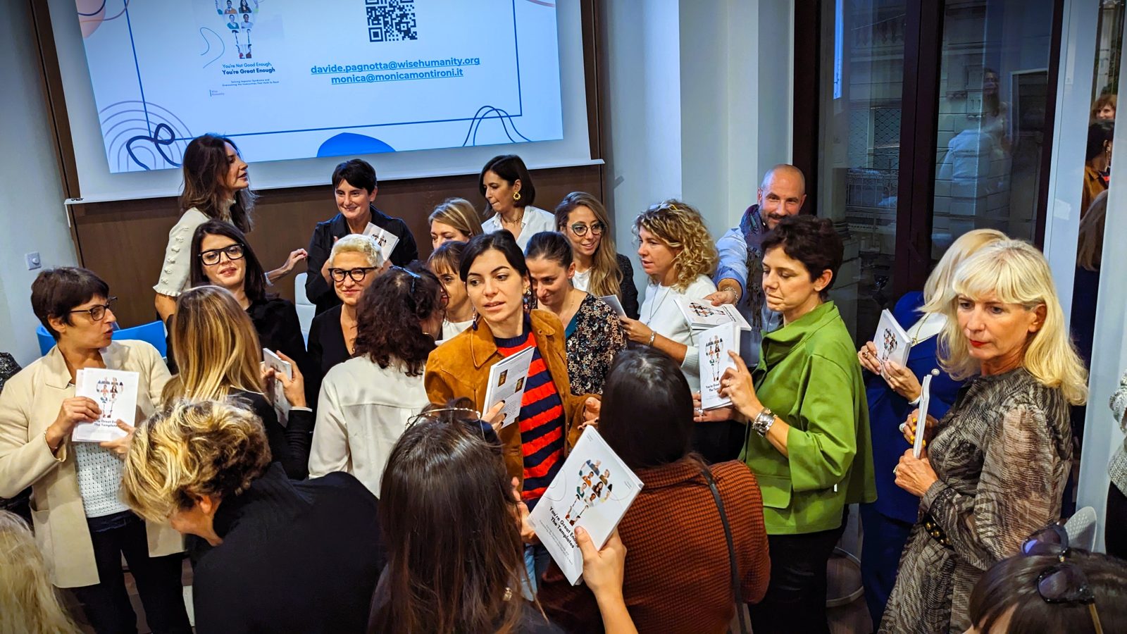 Participants holding up their copies of the book