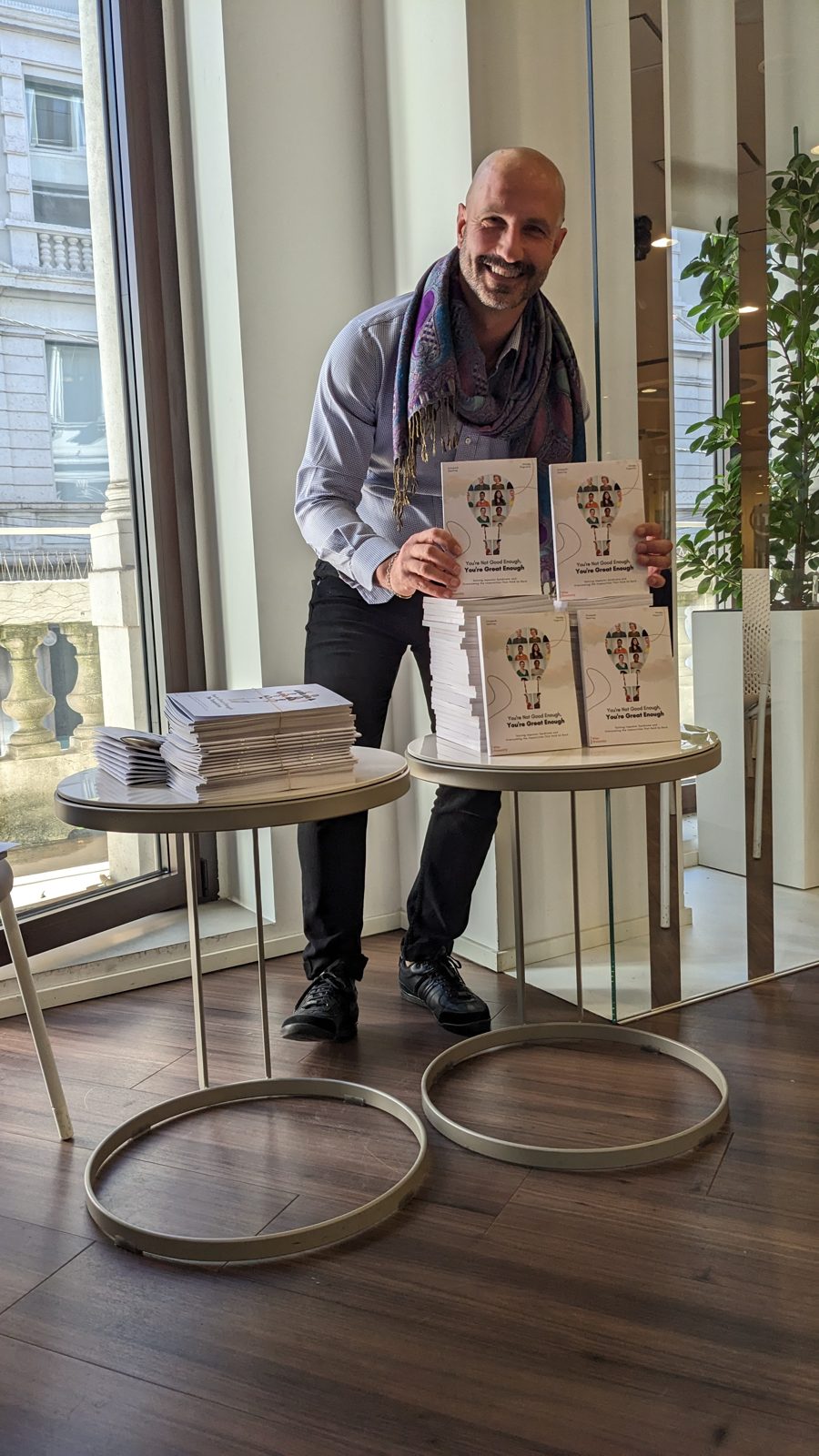 Stacks of the book laid out on a table before the workshop