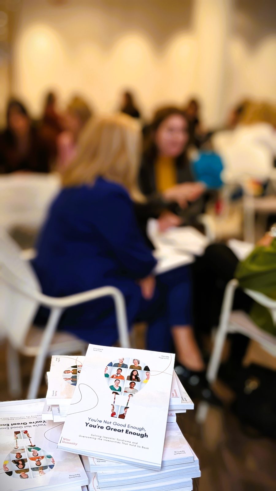 Copies of the book beside participants working in groups