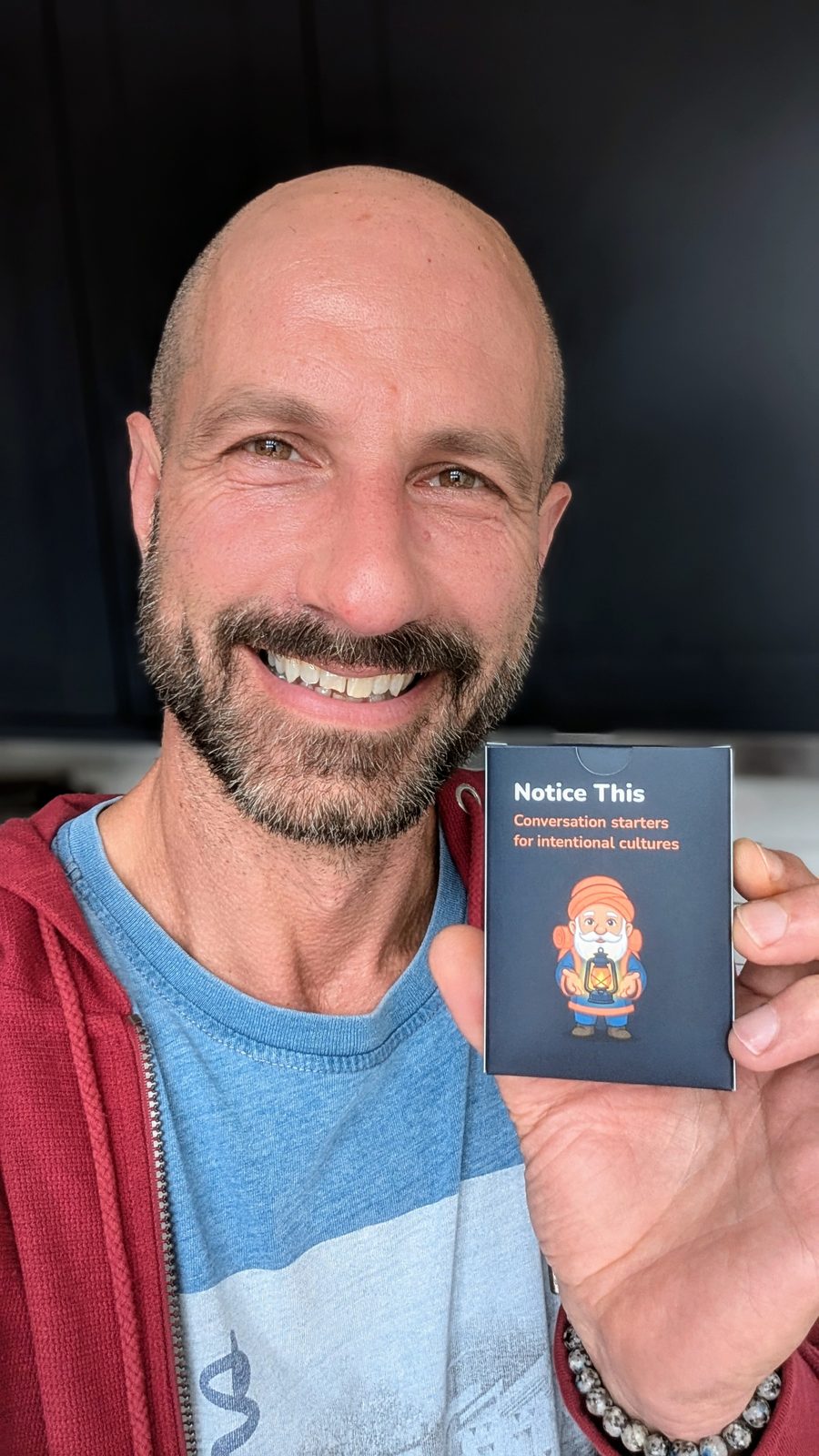 Davide holding a deck of Notice this cards