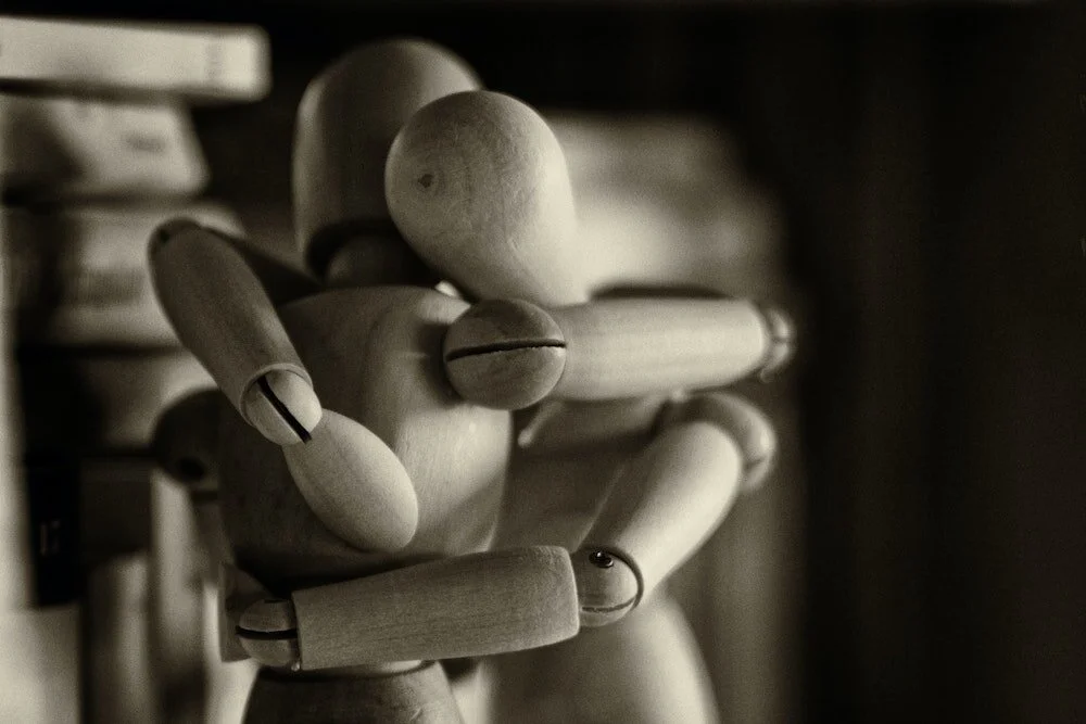 two artist mannequins embrace how to be happier.jpg